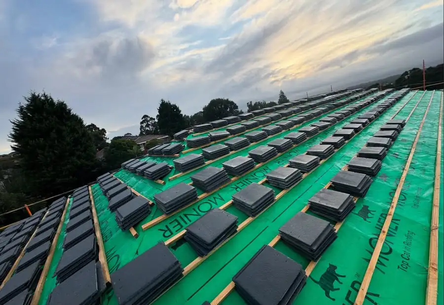New roof tiles laid out on sarking ready to fix
