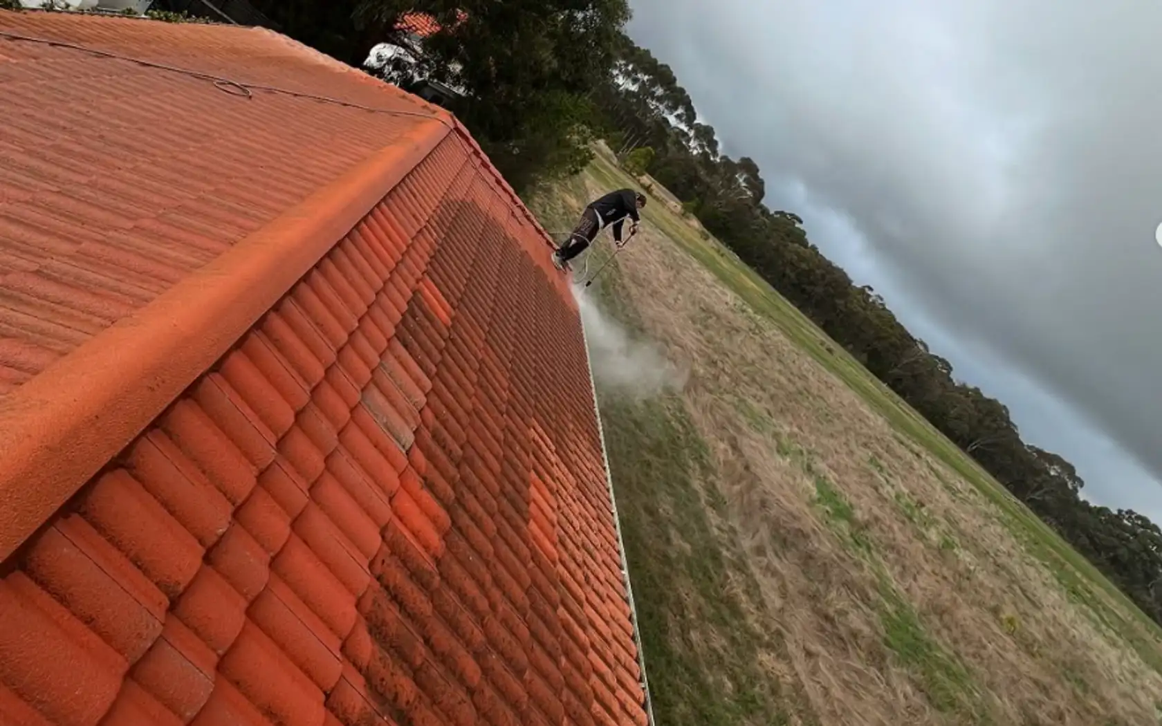 High-pressure cleaning a terracotta tiled roof in Mornington